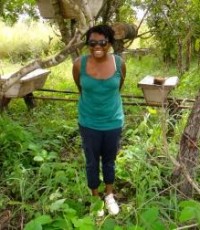 Alison standing in front of LWF's apiary management project.