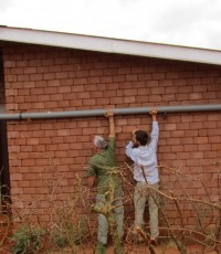 Stephen and his father look at fixing a pipe when his parents visited him at Nyumbani.