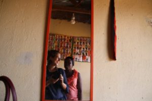 Joking around with Vitaline, an IRC co-worker, with the camera in between interviews with beneficiaries at the Tungane tailoring group, Nsambya-Kirombe